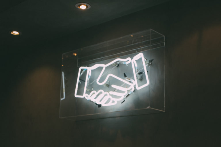 Shaking hands neon light