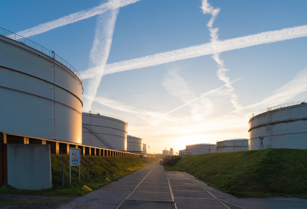 several large storage tanks for petrol in the Rotterdam Port at sunrise