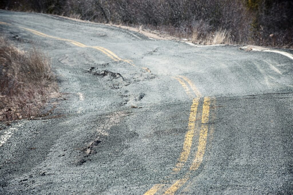 The effects of global warming as the permafrost leaves the ground near Yellowknife in Canada's Northwest territories. The pavement is buckled and potholed