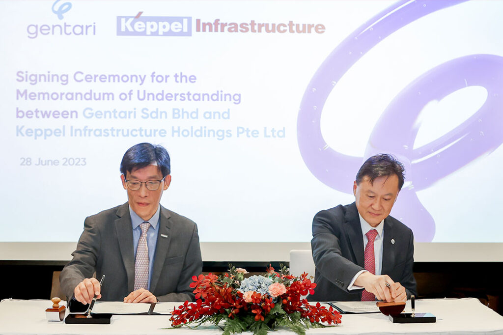 Two men signing papers