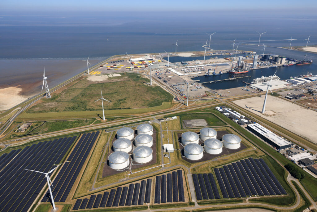 Aerial view of Eemshaven port with storage tanks and offshore wind