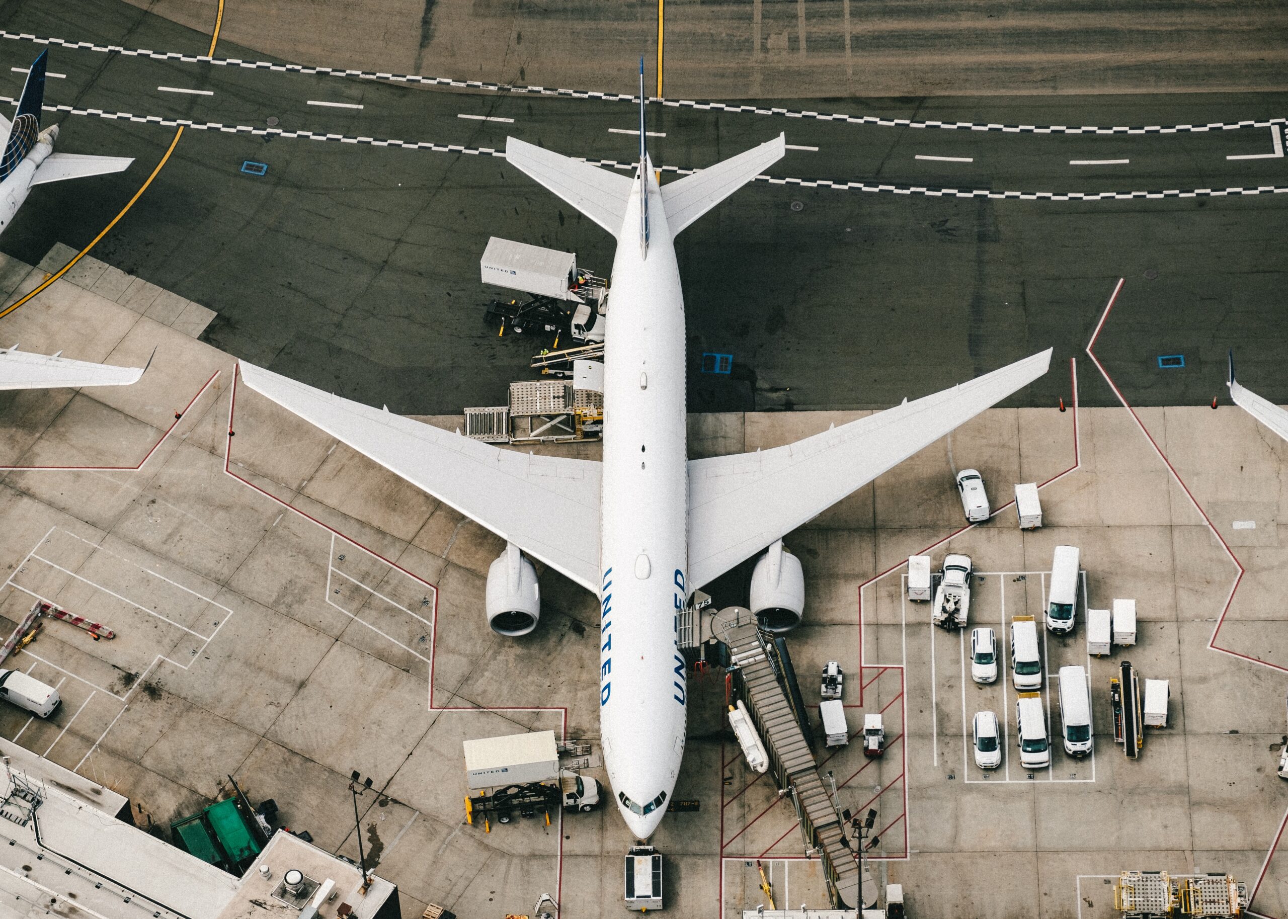 Aerial view of an aeroplane being loaded on the tarmac