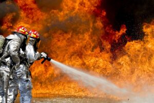 Chemical firefighter tackles blaze with hose
