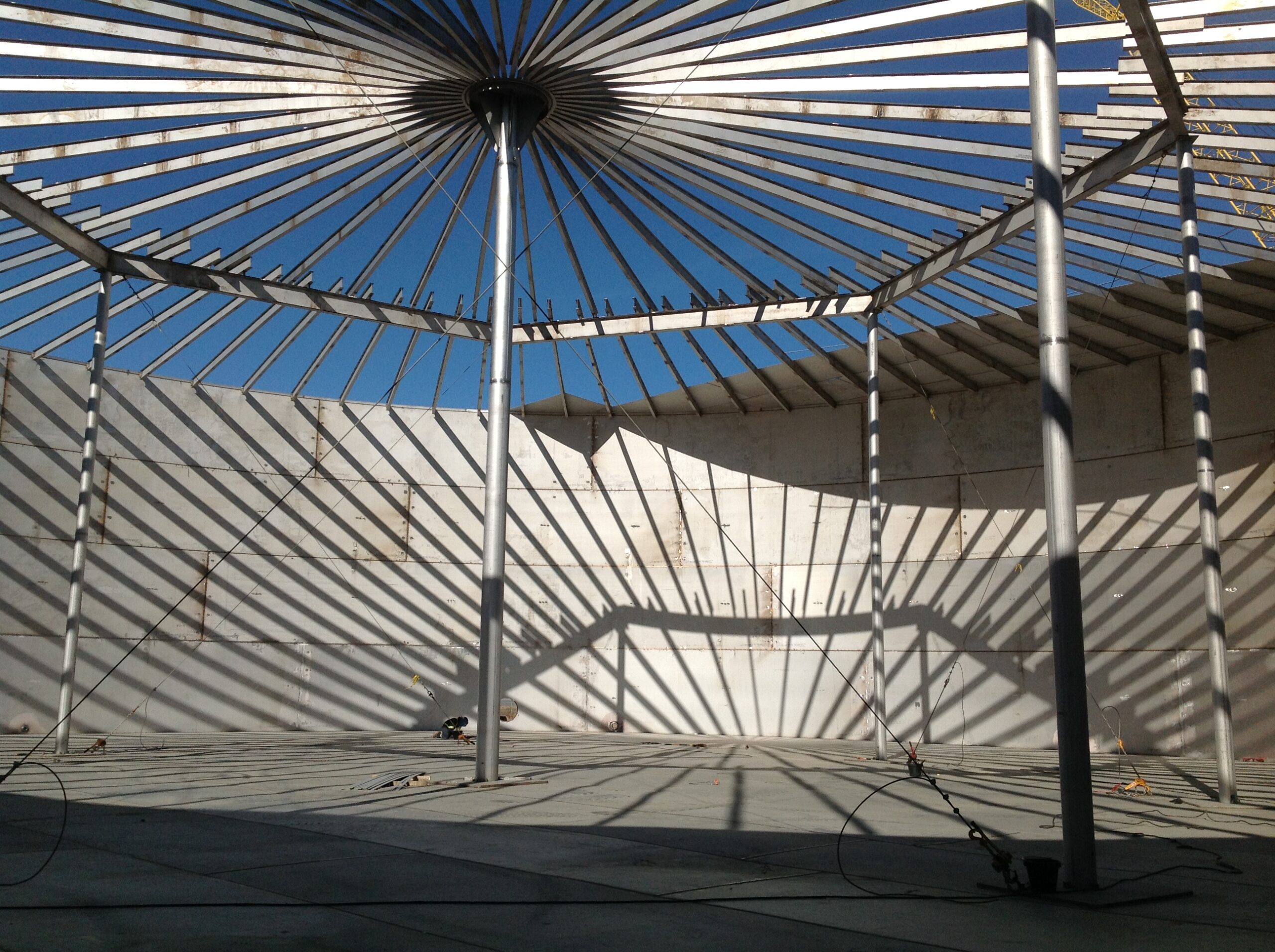 A metal structure with a shadow on the ground