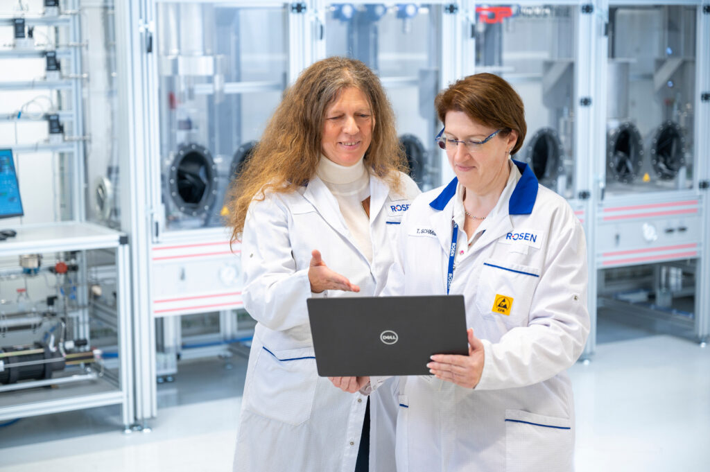 Two scientists looking at laptop