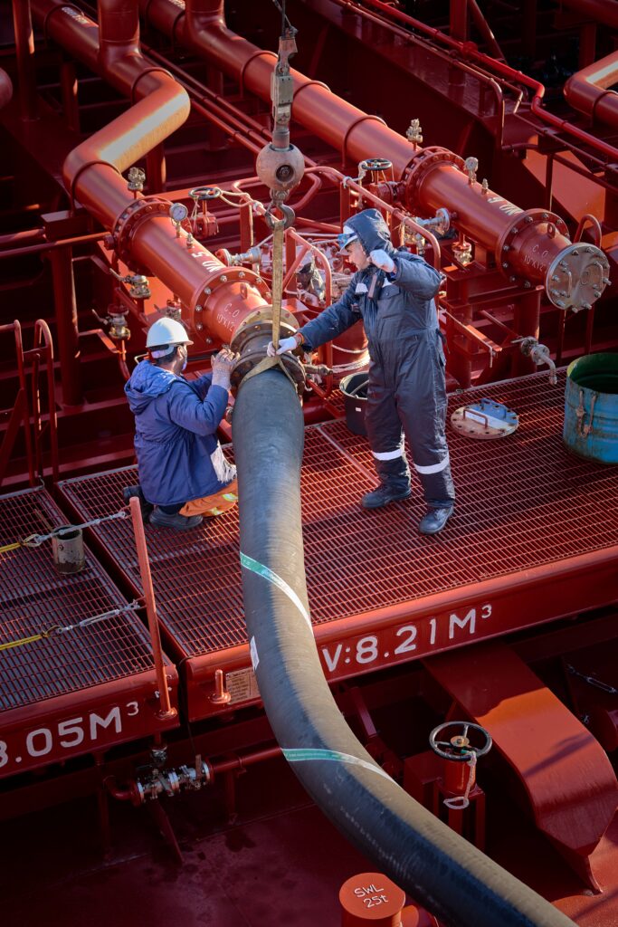 a group of men working on a large pipe