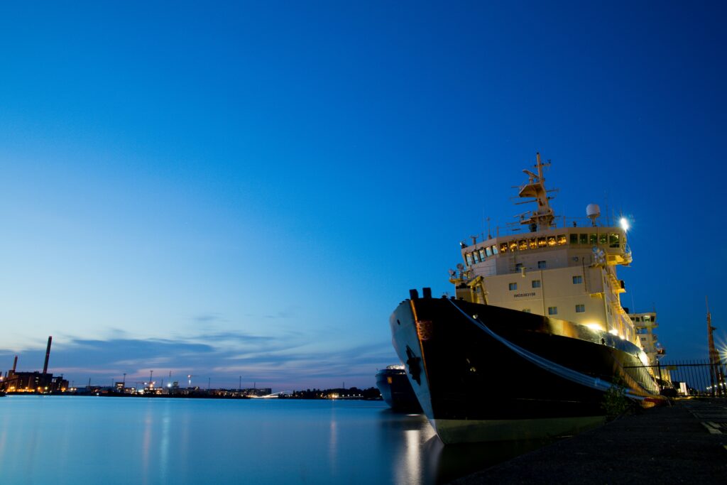 white and black ship at dusk