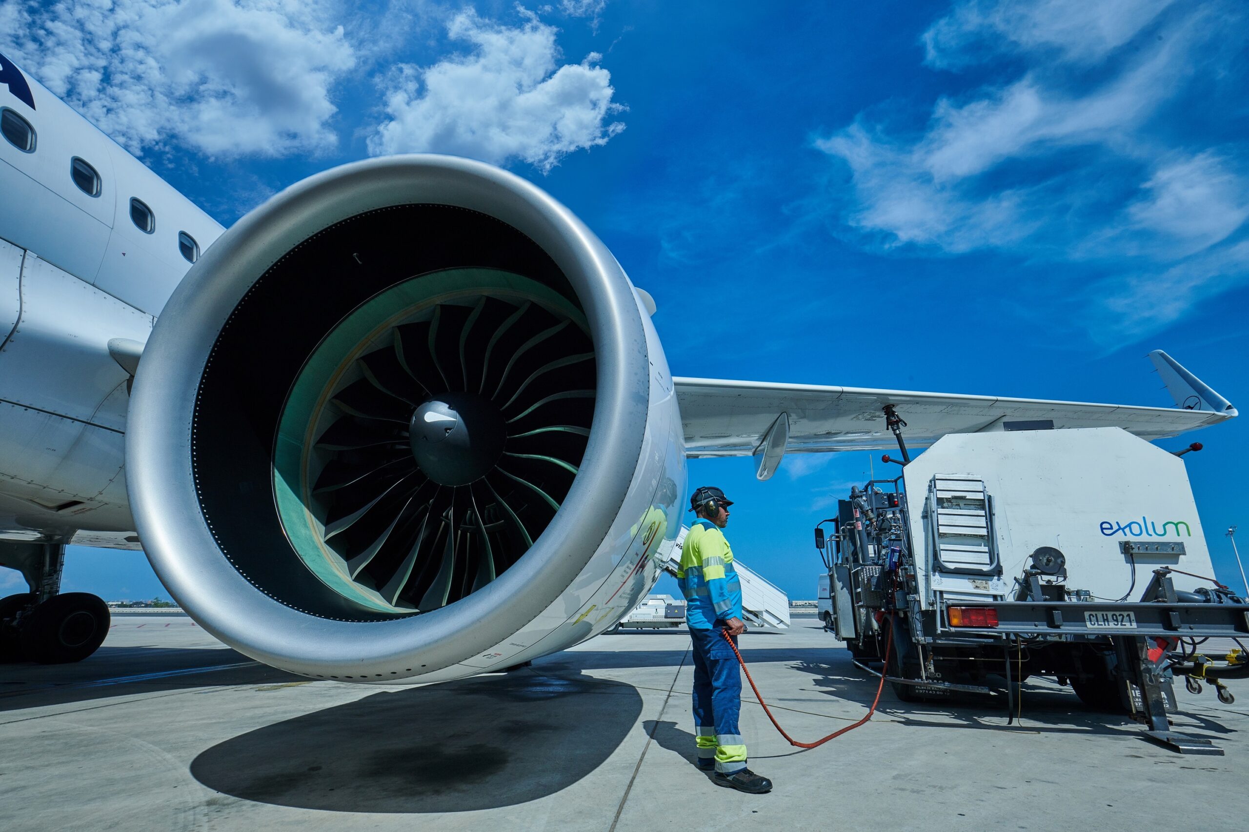 Man next to aeroplane engine with Exolum logo